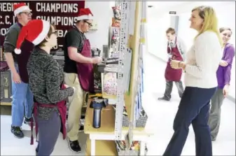  ?? PETER HVIZDAK - NEW HAVEN REGISTER ?? Matthew Toole, Emma Grace, Jack Shuckerow and Robert Magowan, left to right, serve customers at Parsons Perks! A Community Cafe at the Parsons Government Center in Milford Wednesday, December 21, 2016. Parsons Perks is a snack bar operated by older...