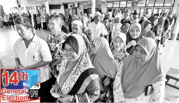  ??  ?? People queuing up to cast their vote at the polling station at Sekolah Agama Menengah Unwanus Saadah Kanchong Darat in Selangor yesterday. - Bernama photo