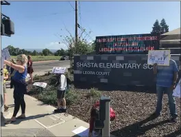  ?? SHARON MARTIN — ENTERPRISE-RECORD ?? Parents from the Chico Parents for In-Person Learning group take part in a rally Tuesday morning outside Shasta Elementary School.