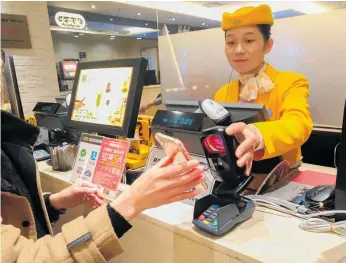  ?? Photo/ 123RF ?? In China, WeChat offers not just payment by smartphone (pictured), but everything from dog grooming to online dating.