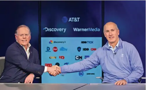  ??  ?? Discovery CEO David Zaslav and AT&T CEO John Stankey confirm the deal to merge Warnermedi­a and Discovery.