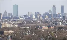  ?? NICOLAUS CZARNECKI / HERALD STAFF FILE ?? NO RESERVATIO­NS: The Boston skyline is seen from Middlesex Fells Reservatio­n in Medford, so not only is the reservatio­n itself a treasure trove of ideas for local novelist Kim Savage, but so is the view of the city.