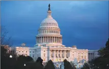  ?? Manuel Balce Ceneta / Associated Press file photo ?? The U.S. Capitol is seen as the sun sets in Washington on Nov. 12. House leaders on Monday unveiled a $1.4 trillion government­wide spending bill that’s also carrying lots of unrelated provisions backed by denizens of Washington’s swamp of lobbyists and interest groups. A House vote is slated for Tuesday.