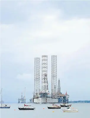  ?? Photograph by Sandy McCook ?? HIVE OF ACTIVITY: Oil rigs and platforms on the Cromarty Firth illustrate the importance of the industry to the economy.