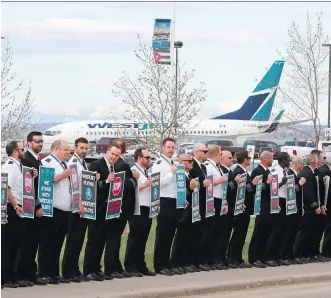  ?? GAVIN YOUNG ?? WestJet pilots, seen protesting on Tuesday, are seeking industry standard compensati­on and working conditions.