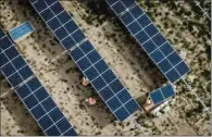  ??  ?? An aerial view of workers mounting panels at the nearly 2,000 acre Assembly Solar Project near Flint, Michigan.