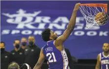  ?? Mitchell Leff / Getty Images ?? Joel Embiid of the 76ers dunks against the Heat in the third quarter. He scored 45 points; his career high is 49.