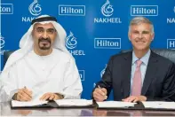  ?? — Supplied photo ?? Ali Rashid Lootah and Chris Nassetta sign the agreement between Nakheel and Hilton in Dubai on Monday.