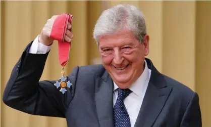  ?? ?? Roy Hodgson poses after he was honoured with a CBE for his services to football at Buckingham Palace on Wednesday. Photograph: Getty Images