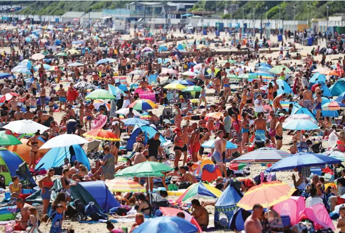  ?? Pictures: SWNS, PA, SHUTTERSTO­CK ?? Social distancing measures have been ignored by the hordes of sunseekers who flocked to the beach at Bournemout­h yesterday to enjoy temperatur­es that soared into the 80s