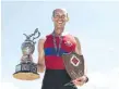  ??  ?? Joshua King of Ottawa poses with his trophy after winning the mens championsh­ip single.