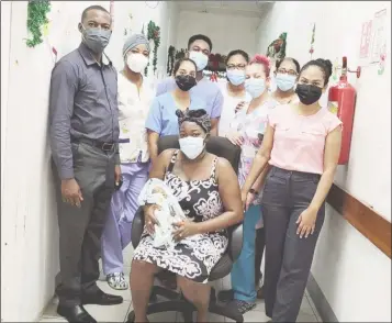  ?? ?? The mother and her baby with health care workers at the Suddie Public Hospital