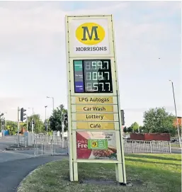  ?? Picture: PA ?? A Morrisons supermarke­t sign selling unleaded petrol at 99.7p per litre at its store in Belle Vale, Liverpool, after the chain reduced its prices across its UK forecourts.