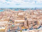  ?? DREAMSTIME ?? An aerial view of Our Lady of Mount Carmel Church and St. Paul’s Cathedral in Valletta, Malta.