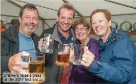  ?? ?? Drinkers raise a glass at the 2017 festival