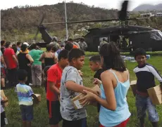  ?? (Lucas Jackson/Reuters) ?? RESIDENTS TAKE relief supplies delivered by soldiers working with a 101st Airborne Division ‘Dustoff’ unit assisting in recovery efforts following Hurricane Maria in Jayuya, Puerto Rico, last week.