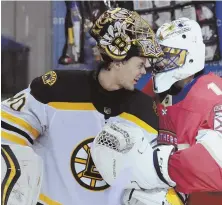  ?? AP PHOTO ?? MUTUAL ADMIRATION: Bruins goalie Tuukka Rask salutes his Panthers counterpar­t, Roberto Luongo, who played in his 1,000th career regular-season game last night in Sunrise, Fla. The Bruins lost, 3-2.