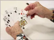  ?? LYNN KUTTER ENTERPRISE-LEADER ?? Bonnie Beeks, of Farmington, looks over her hand for the card game, Pitch. She and other senior adults were playing cards at the Farmington Senior Activity and Wellness Center last week. The goal of Pitch is to score the most points by winning tricks.