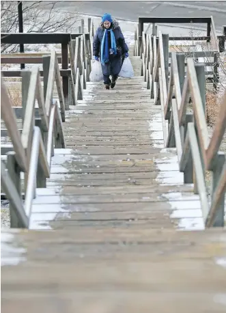  ?? GAVIN YOUNG ?? A dusting of snow frames a staircase above Centre Street on Monday. More snow is expected over the next two days and motorists are being advised to take precaution­s.