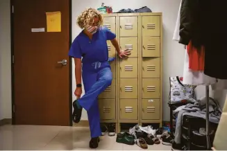  ?? ?? Dr. Rebecca Taub puts on scrubs and shoes in the locker room at the Trust Women clinic in Oklahoma City. She says protesters concern her but also motivate her to continue the work.