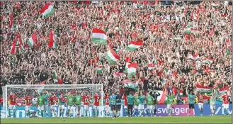  ??  ?? Hungary’s players celebrate with their fans after the Euro 2020 soccer championsh­ip group F match between Hungary and France at the Ferenc Puskas stadium in Budapest.
(AP/Tibor Illyes)