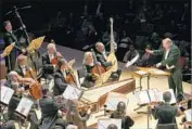  ?? Marcus Yam Los Angeles Times ?? NICHOLAS McGEGAN conducts Philharmon­ia Baroque at Disney Hall during 35th anniversar­y tour.