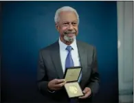  ?? (AP/Matt Dunham) ?? Abdulrazak Gurnah, a Tanzanian-born novelist and emeritus professor who lives in the UK, poses for photograph­s Monday with his 2021 Nobel Prize for Literature medal after the Ambassador of Sweden Mikaela Kumlin Granit presented the award in a ceremony at the Swedish Ambassador’s Residence in London.