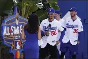  ?? MARK J. TERRILL – THE ASSOCIATED PRESS ?? The Dodgers’ Mookie Betts speaks with MLB Network’s Alanna Rizzo as Walker Buehler, second from right, and Cody Bellinger look on during Tuesday’s All-star launch event.