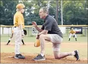  ?? Gravitas Ventures ?? TIMMY (Brogan Hall), left, with Little League coach Don (John C. McGinley), who is a drill-sergeant type.