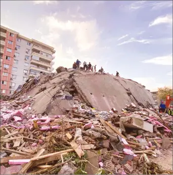  ??  ?? Rescue workers trying to save people trapped in the debris of a collapsed building, in Izmir, Turkey, October 30, 2020