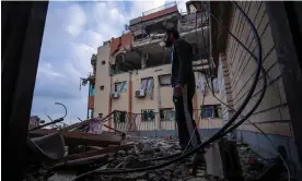  ?? Photograph: Fatima Shbair/AP ?? A Palestinia­n man inspects damage to his building following Israeli airstrikes on the apartment of an Islamic Jihad commander in Gaza City, Tuesday 9 May 2023.