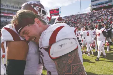  ?? Arkansas Democrat-Gazette/Benjamin Krain ?? ROAD WIN: Arkansas offensive lineman Hjalte Froholdt, front, celebrates with Paul Ramirez after the Razorbacks defeated Ole Miss, 38-37, on Oct. 28, 2017, at Vaught–Hemingway Stadium at Hollingswo­rth Field in Oxford, Miss.