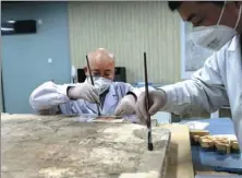  ?? ZHANG YUAN / CHINA NEWS SERVICE ?? Technician­s restore an ancient fresco at the Shaanxi History Museum in Xi’an, Shaanxi province.