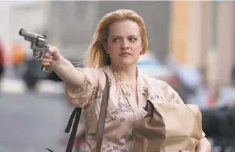  ?? Alison Cohen Rosa / Warner Bros. ?? Elisabeth Moss gives a powerhouse performanc­e as an Irish mafia wife who teams up with two others to take over the mob in Hell’s Kitchen in the crime drama “The Kitchen.”