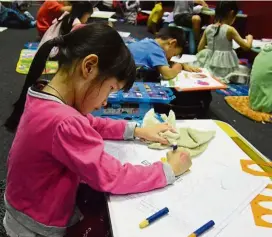  ??  ?? Children who love to colour can participat­e in Bookfest’s ‘assuredly exciting’ colouring competitio­n, happening on June 3 at the KL Convention Centre. We hear this little artist had a great time at a previous competitio­n! — Photos: Filepics