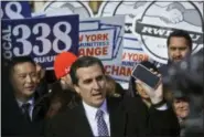  ?? BEBETO MATTHEWS — THE ASSOCIATED PRESS FILE ?? New York State Sen. Michael Gianaris, center, calls on supporters to remove the Amazon app from their phones and boycott the company, as he address a coalition rally and press conference in New York. The first clue that opposition to the project could succeed in derailing the deal came in early February, when Gianaris was appointed to a seat on a state panel that often has to approve state funding for big economic developmen­t projects. According to the rules governing the 5-member Public Authoritie­s Control Board, funds for any individual project can be vetoed by a single member, meaning that if the Amazon deal went before the board, Gianaris could kill it unilateral­ly.