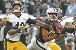  ??  ?? Oakland’s Seth Roberts makes a 39-yard catch against Morgan Burnett, left, and Terrell Edmunds to set up the winning touchdown.