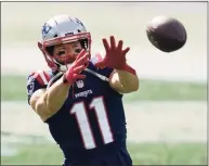  ?? Charles Krupa / Associated Press ?? Patriots wide receiver Julian Edelman, shown warming up before Sunday’s game against the Broncos, is among the offensive performers who haven’t been delivering consistent­ly this season.