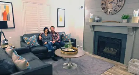  ?? TRACY HANES ?? Ashley and Adam McFarland in their new family room. The updated decor includes wide-plank laminate flooring and a white-grey-black palette.