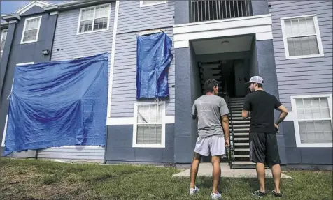  ?? Jacob Langston/Orlando Sentinel via AP ?? Residents at Westbrook Apartments get a first look at their building June 12, 2018, in Orlando, Fla., where a gunman held four children hostage before taking their life and his own.