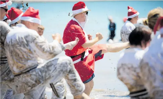  ?? Photos / Dean Purcell ?? Go-Kan Ryu Karate-Do members, led by Sensei Hayden Gwynne (above), celebrate their year’s end in the sun at Browns Bay beach yesterday.