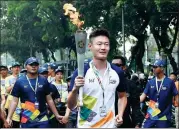  ?? YUE YUEWEI / XINHUA ?? Chinese athlete Zhang Peimeng participat­es in a torch relay in Jakarta, Indonesia, on Thursday ahead of the 2018 Asian Games, which start there on Saturday.