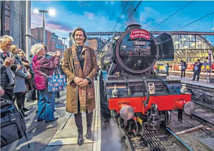  ??  ?? Penny Vaudoyer, Alan Pegler’s daughter, with the Flying Scotsman at King’s Cross at the start of the special journey to York