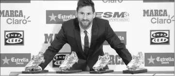  ??  ?? Messi poses with his four Golden Boot trophies during a ceremony in Barcelona, Spain. — Reuters photo