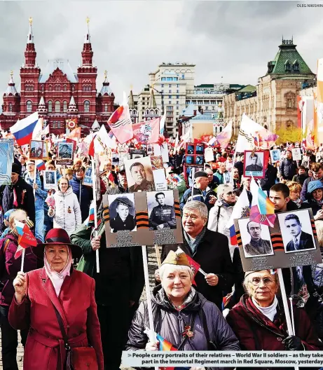  ?? OLEG NIKISHIN ?? > People carry portraits of their relatives – World War II soldiers – as they take part in the Immortal Regiment march in Red Square, Moscow, yesterday