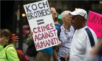  ?? Photograph: Carlo Allegri/REUTERS ?? A protester holds up a sign against the Koch Brothers at the ‘People’s Climate March’ in Manhattan in September 2014.