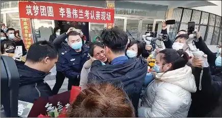  ?? (AP/The Paper) ?? In this image taken from video, Li (with his back to camera) is reunited with his mother Saturday in Lankao in central China’s Henan Province.