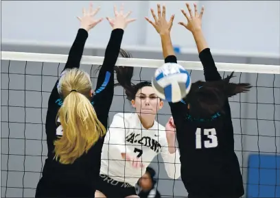  ?? CHRIS RILEY — TIMES-HERALD, FILE ?? Solano College’s Haley Del Rio squeezes the ball between the block of two Folsom Lake defenders during a Falcons’ match in 2019. There will not be any women’s volleyball until the fall of 2021 at the earliest.