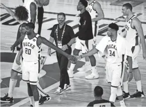  ??  ?? The Bucks walk off the court Monday after beating the Magic.
POOL PHOTO