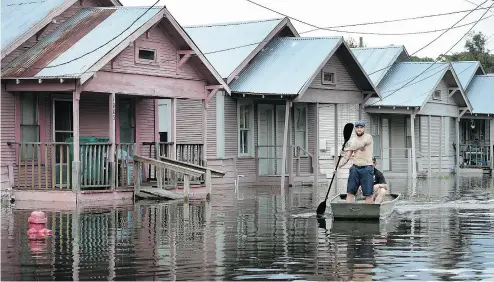  ??  ?? Marine veteran Rocky Damico searches for residents in need of help in the aftermath of Hurricane and Tropical Storm Harvey. The devastatio­n could bring a change in outlook to notoriousl­y regulation-shy Texans.